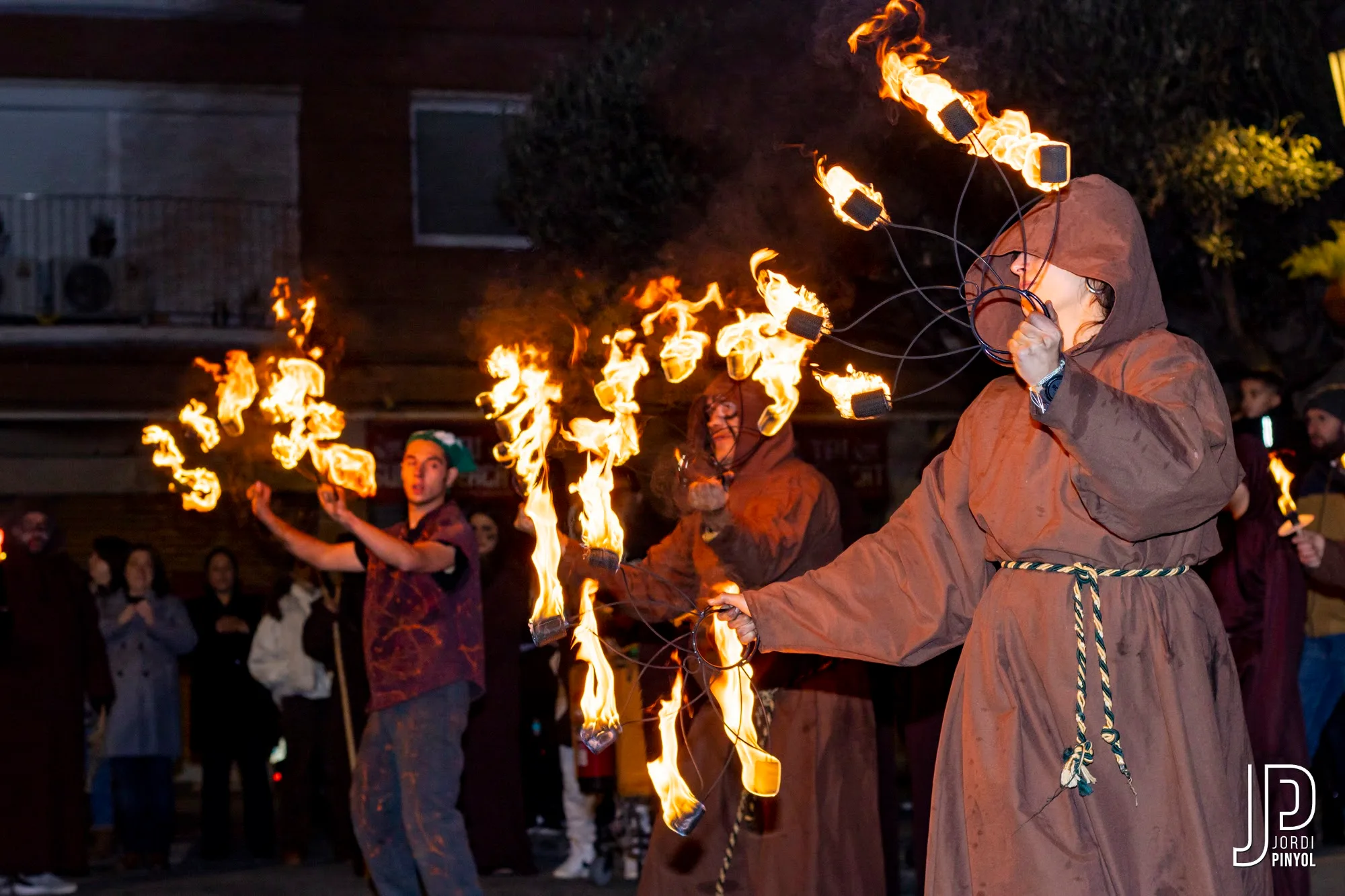 Malabaristes de foc amb ventalls encesos al seguici del Llagasta